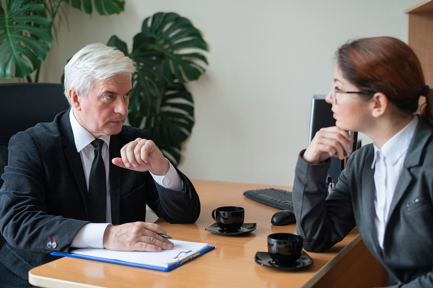 elderly man interviewing young woman
